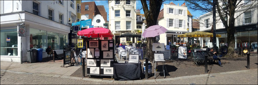 Selling and taking art commissions from a street stall in Brighton